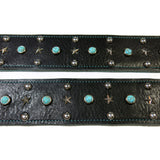 Close up of Black leather guitar strap with vintage turquoise cabochons and silver stars and domes hardware