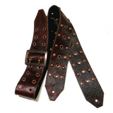 A burgundy textured leather guitar strap with a copper buckle, featuring decorative brass studs and star-shaped accents.