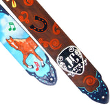 A close-up of a decorative guitar strap with a dark brown leather base, and Kidskin overlays of a horseshoe and decorative elements.  The back features a blue airbrushed sky and a highly detailed horse, created from Kidskin overlays.