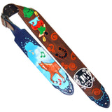A hand-painted leather guitar strap featuring a brown body with orange swirls, a horseshoe motif, and a colorful cowboy boot illustration, paired with a blue end cap decorated with a cowboy horse, musical notes, and a black-and-white monogrammed copy of the artist, JC Harrison's logo.