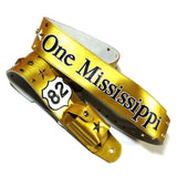 A metallic gold leather guitar strap featuring Steve Azar's song "One Mississippi" in Kidskin overlays, a Route 66 '82' Kidskin shield, and a wireless transmitter pocket on the back.